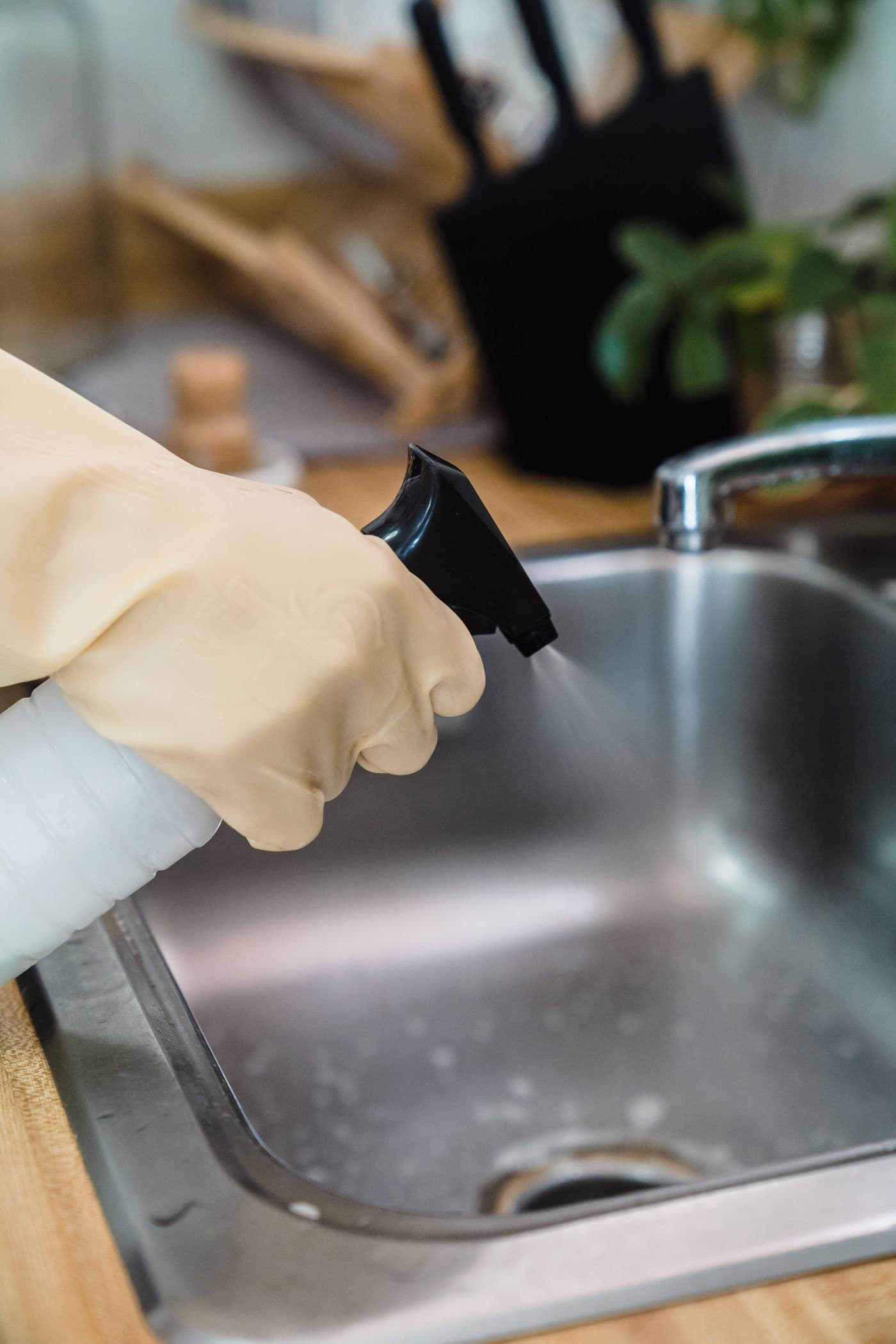 A cleaner working on a kitchen sink
